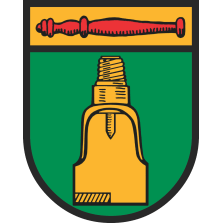 Wappen Nienhagen. Unterer Teil in dunkelgrün, oben ein breiter gelber Streifen mit einem roten Stab, im dunkelgrünen Bereich ist ein gelber Ölbohrkopf.